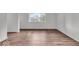 Bright room with modern flooring, neutral paint, and ample natural light from the window at 4956 W 11Th St, Speedway, IN 46224