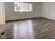 Spacious living room featuring new laminate flooring and ample natural light at 4956 W 11Th St, Speedway, IN 46224