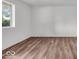 Bright room with modern flooring, neutral paint, and ample natural light from the window at 4956 W 11Th St, Speedway, IN 46224
