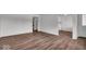 Bright living room with modern flooring and neutral paint leading into the kitchen area at 4956 W 11Th St, Speedway, IN 46224