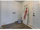 Spacious room with a door, neutral paint, and updated flooring at 4956 W 11Th St, Speedway, IN 46224