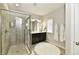 Bathroom featuring a glass shower, vanity with double sinks, and a decorative rug at 5755 Buskirk Dr, Indianapolis, IN 46216