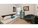 Well lit room with a cream colored couch and a comfy looking papasan chair at 5755 Buskirk Dr, Indianapolis, IN 46216