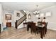 Dining area with hardwood floors, stylish lighting, staircase and ample space for entertaining at 5755 Buskirk Dr, Indianapolis, IN 46216