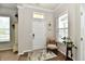 Welcoming foyer with a front door, a chair, and a small table at 5755 Buskirk Dr, Indianapolis, IN 46216