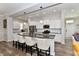 Modern kitchen with island seating, stainless steel appliances, and white cabinetry offers an inviting space at 5755 Buskirk Dr, Indianapolis, IN 46216
