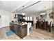 Open-concept kitchen boasts a spacious island, stainless steel appliances, and seamless flow to living spaces at 5755 Buskirk Dr, Indianapolis, IN 46216