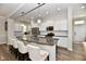 Modern kitchen featuring a large island with seating, stainless steel appliances, and a bright atmosphere at 5755 Buskirk Dr, Indianapolis, IN 46216