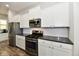 Stylish kitchen with stainless steel appliances, sleek cabinetry, and modern finishes at 5755 Buskirk Dr, Indianapolis, IN 46216