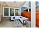 Cozy patio with a white cushioned couch, gas fire pit, and wood privacy fence providing an outdoor living space at 5755 Buskirk Dr, Indianapolis, IN 46216