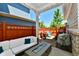 Relaxing covered patio with comfortable seating and a view of the fenced backyard at 5755 Buskirk Dr, Indianapolis, IN 46216