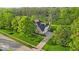 Sprawling brick home with mature landscaping, a three-car garage, and a well-maintained lawn at 5783 Coopers Hawk Dr, Carmel, IN 46033