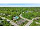 Aerial view of a neighborhood with mature trees, a pool, and well-manicured lawns at 5783 Coopers Hawk Dr, Carmel, IN 46033