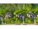 Aerial view of homes with mature trees and green lawns in a suburban neighborhood at 5783 Coopers Hawk Dr, Carmel, IN 46033
