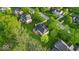 Aerial view of home with backyard deck, surrounded by trees and lush green lawn at 5783 Coopers Hawk Dr, Carmel, IN 46033
