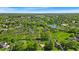 Scenic aerial view of the community featuring lush green trees and various neighborhood homes in a peaceful setting at 5783 Coopers Hawk Dr, Carmel, IN 46033