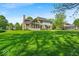 Spacious backyard with lush lawn and charming two-story home at 5783 Coopers Hawk Dr, Carmel, IN 46033