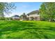 Expansive grassy backyard featuring a well-maintained two-story home at 5783 Coopers Hawk Dr, Carmel, IN 46033