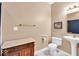 Bathroom with pedestal sink, toilet, decorative vanity, and modern fixtures at 5783 Coopers Hawk Dr, Carmel, IN 46033