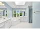 Bathroom featuring a soaking tub, double vanity, and large windows at 5783 Coopers Hawk Dr, Carmel, IN 46033