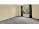 An empty bedroom with a large window and dark curtains at 5783 Coopers Hawk Dr, Carmel, IN 46033