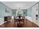 Formal dining room with a wooden table set, elegant chandelier, and classic decor, ideal for entertaining guests at 5783 Coopers Hawk Dr, Carmel, IN 46033