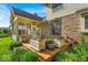 Exterior view of a brick home with screened in porch and potted flowers on the deck at 5783 Coopers Hawk Dr, Carmel, IN 46033