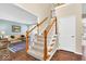 Inviting foyer with staircase, hardwood floors, and a view into the adjacent living room at 5783 Coopers Hawk Dr, Carmel, IN 46033