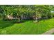 Charming two-story brick home with mature trees and lush green lawn at 5783 Coopers Hawk Dr, Carmel, IN 46033
