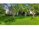 Charming two-story brick home with mature trees and lush green lawn at 5783 Coopers Hawk Dr, Carmel, IN 46033