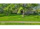 Charming two-story brick home with mature trees and lush green lawn at 5783 Coopers Hawk Dr, Carmel, IN 46033