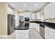 Modern kitchen with stainless steel appliances, granite countertops, and white cabinetry, designed for functionality at 5783 Coopers Hawk Dr, Carmel, IN 46033