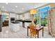 Inviting kitchen with modern appliances, granite countertops, tile floors, and breakfast nook with natural light at 5783 Coopers Hawk Dr, Carmel, IN 46033