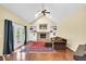 Cozy Gathering room with vaulted ceiling, fireplace, built-in shelving, and plush seating, perfect for relaxation at 5783 Coopers Hawk Dr, Carmel, IN 46033