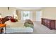 Bright main bedroom with a bed, dressers, and natural light at 5783 Coopers Hawk Dr, Carmel, IN 46033