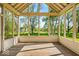 View from screened-in porch looking out to a large grassy yard with mature trees at 5783 Coopers Hawk Dr, Carmel, IN 46033