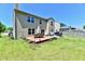 A spacious backyard featuring a wooden deck, seating, and a well-maintained lawn at 5827 High Grass Ln, Indianapolis, IN 46235