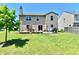 Nice backyard featuring a wooden deck, seating, and a well-maintained lawn at 5827 High Grass Ln, Indianapolis, IN 46235