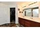 Bathroom featuring a double vanity and a view into the walk in closet at 5827 High Grass Ln, Indianapolis, IN 46235