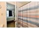 Bathroom with shower with striped curtain and view into bedroom at 5827 High Grass Ln, Indianapolis, IN 46235