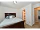 Bedroom with dark wood furniture, bed, carpet and open door to bathroom at 5827 High Grass Ln, Indianapolis, IN 46235