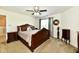 Spacious bedroom featuring a ceiling fan, window and dark wood furniture at 5827 High Grass Ln, Indianapolis, IN 46235