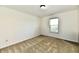 Empty bedroom with carpet flooring, window, and neutral paint at 5827 High Grass Ln, Indianapolis, IN 46235