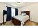 Bedroom with dark furniture, carpet, window with blue curtain and wall mounted TV at 5827 High Grass Ln, Indianapolis, IN 46235