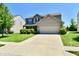 Charming two-story home with a well-manicured lawn, two-car garage, and inviting curb appeal at 5827 High Grass Ln, Indianapolis, IN 46235