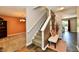 Inviting foyer with staircase, bench, and views into the living spaces at 5827 High Grass Ln, Indianapolis, IN 46235