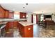 Modern kitchen with dark cabinetry, center island, stainless steel appliances, and tile floors at 5827 High Grass Ln, Indianapolis, IN 46235