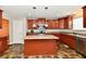 Contemporary kitchen boasts modern appliances, dark cabinets, and a central island for meal preparation at 5827 High Grass Ln, Indianapolis, IN 46235