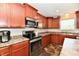 Well-equipped kitchen with stainless steel appliances, dark cabinets, and functional layout at 5827 High Grass Ln, Indianapolis, IN 46235