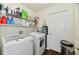 Functional laundry room with appliances, storage shelves, and ample space at 5827 High Grass Ln, Indianapolis, IN 46235